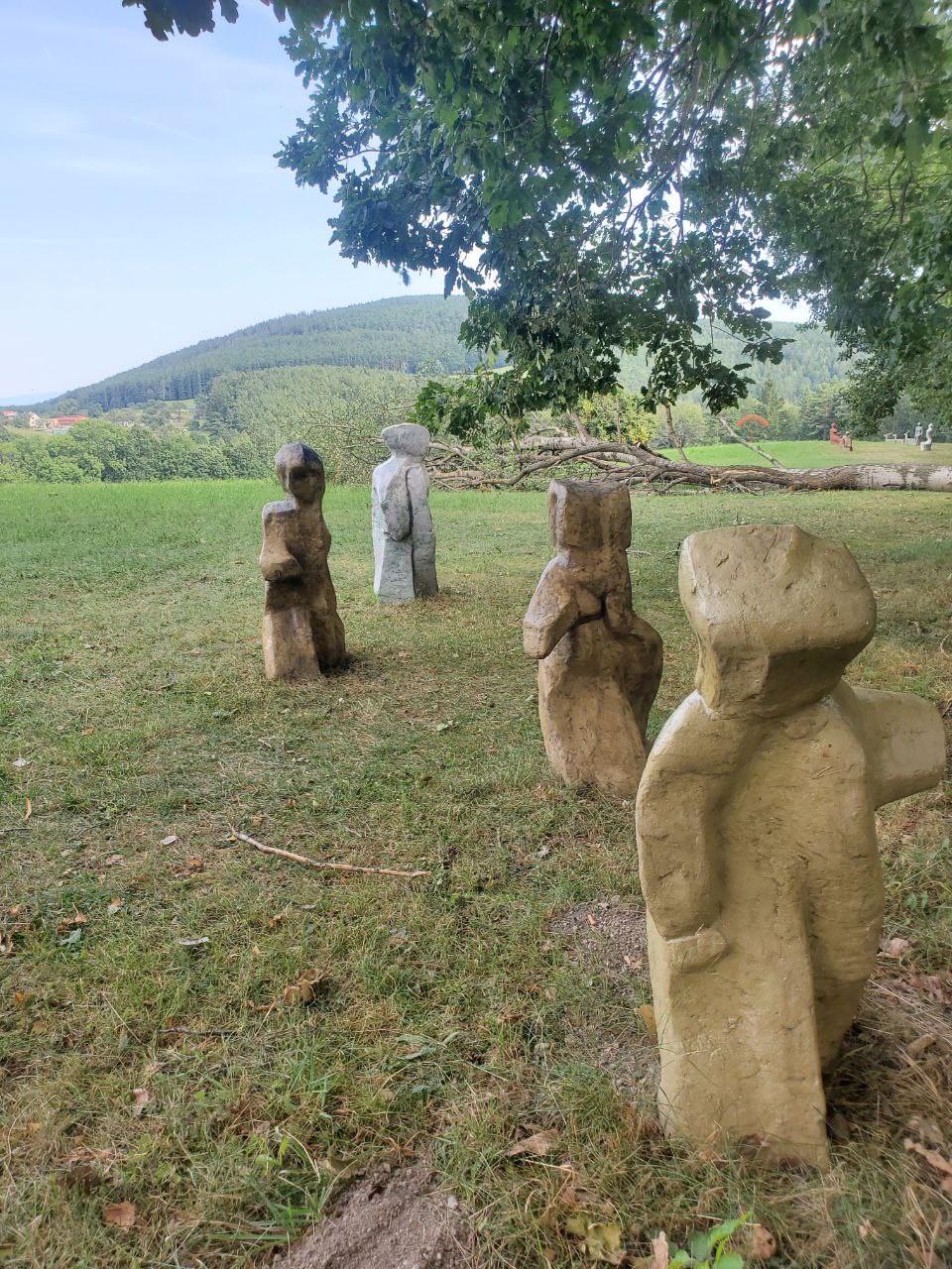 A serene garden with statues and lush greenery.